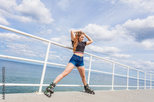 Joyful teen girl wearing roller skates