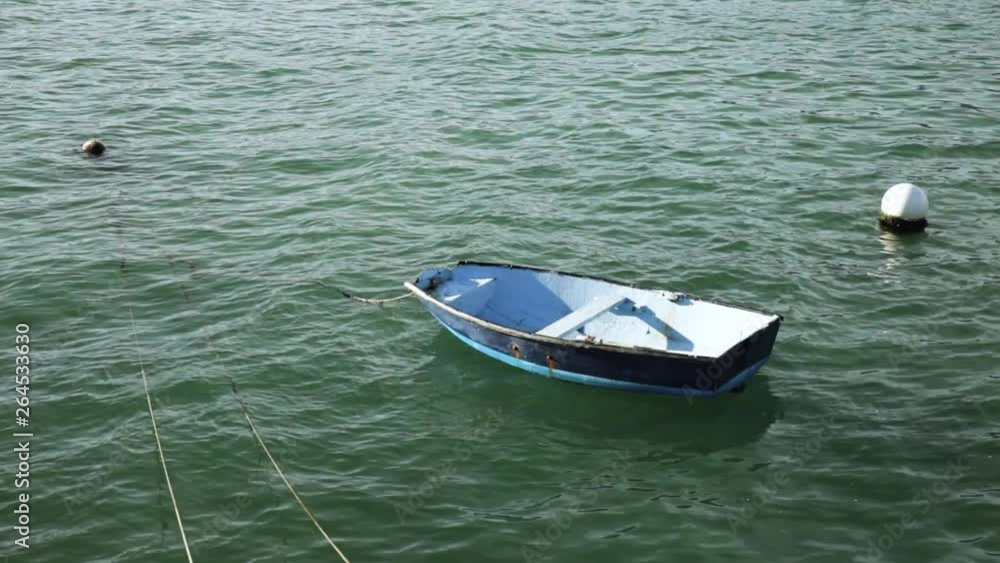 Blue Boat On Sea, Small Dinghy In Ocean Blue Boat On Sea, Small Dinghy In Ocean