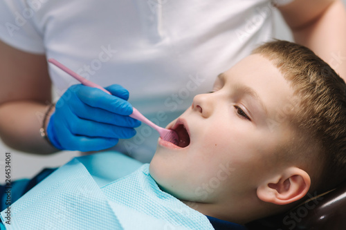 Close up of dentist examination little boy's teeth in clinic