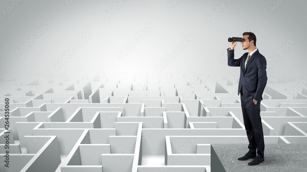 Businessman standing on maze and looking forward to the future concept
