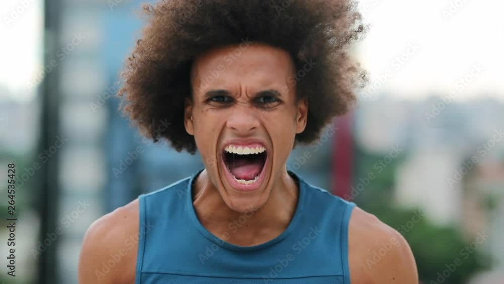 Vidéo Stock Angry african man screaming from the top of his lungs looking to camera | Adobe Stock