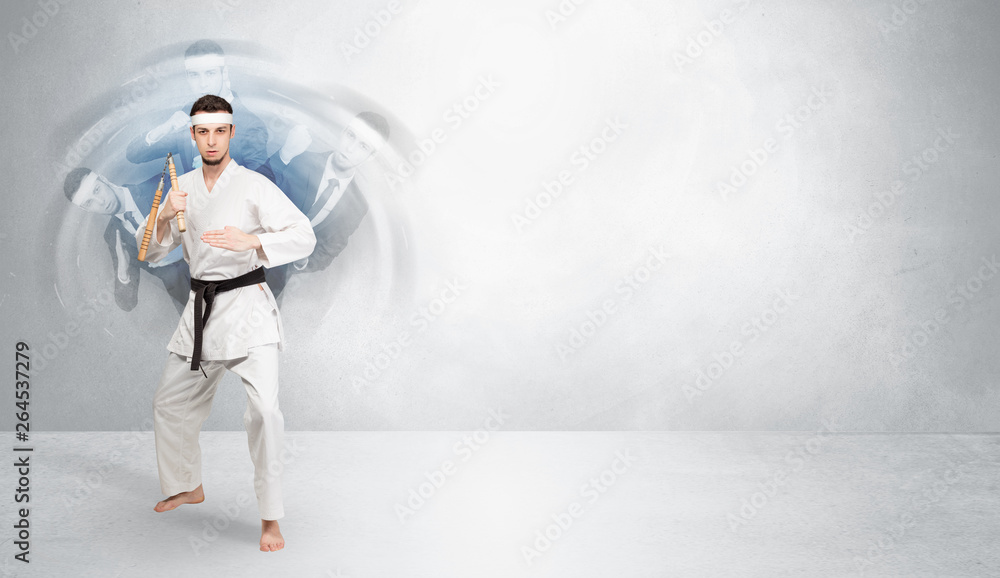 Young businessman in suit fighting with empty wall background
Young businessman in suit fighting with empty wall background