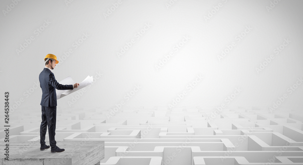 Architect standing on maze and looking at a future plan
Architect standing on maze and looking at a future plan