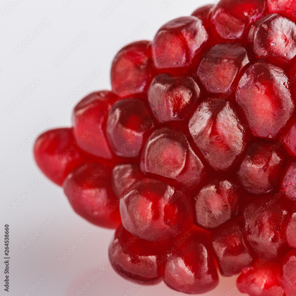 grains of a grenade on a white acrylic background grains of a grenade on a white acrylic background