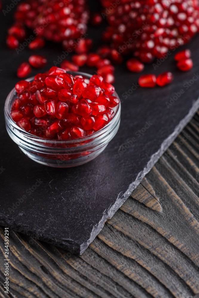 grains of a grenade on a dark rustic background grains of a grenade on a dark rustic background