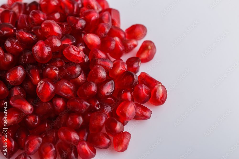 grains of a grenade on a white acrylic background grains of a grenade on a white acrylic background