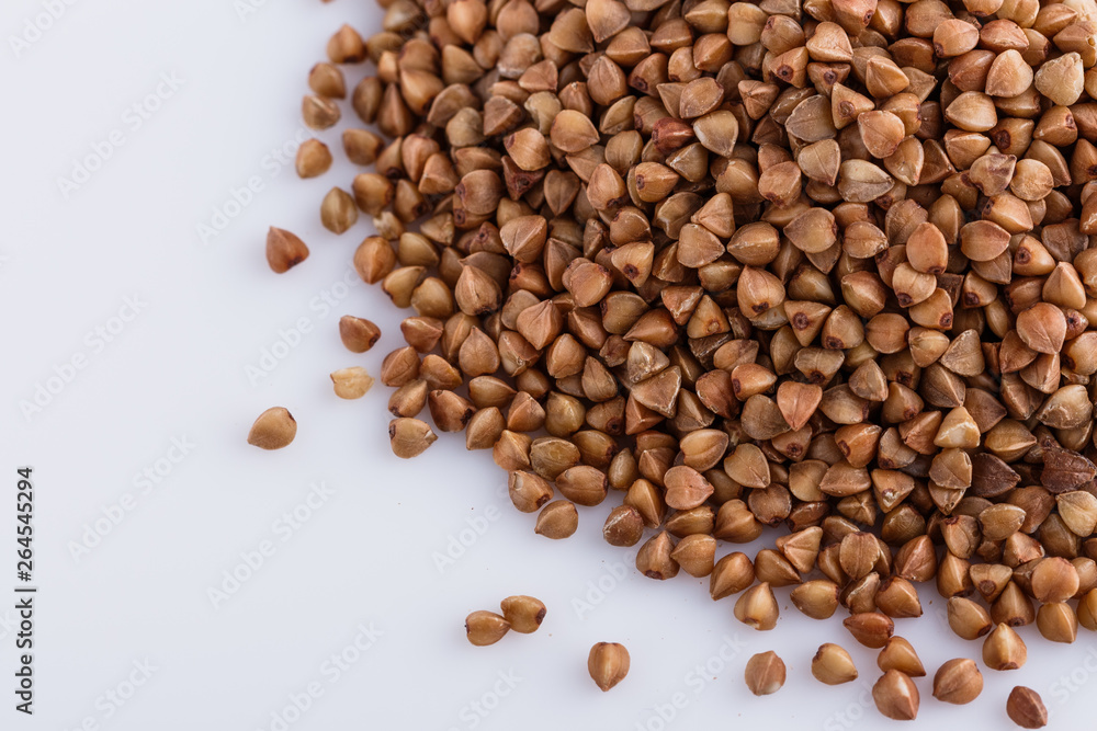 Grain buckwheat on a white acrylic background Grain buckwheat on a white acrylic background