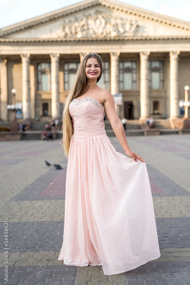 Urban portrait of young, slim, beautiful model in pink dress Urban portrait of young, slim, beautiful model in pink dress