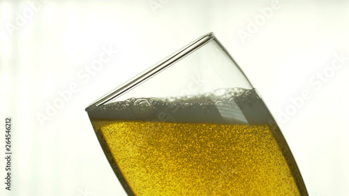 Fotografie Beer is poured into a glass on an isolated background