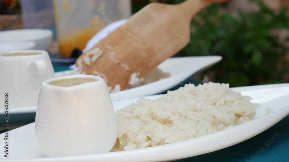 Woman lay Thai sticky rice on a plate before serving. Thai cuisine. Closeup. 4k Woman lay Thai sticky rice on a plate before serving. Thai cuisine. Closeup. 4k