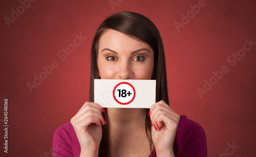 Young person holding adult content card in hand 