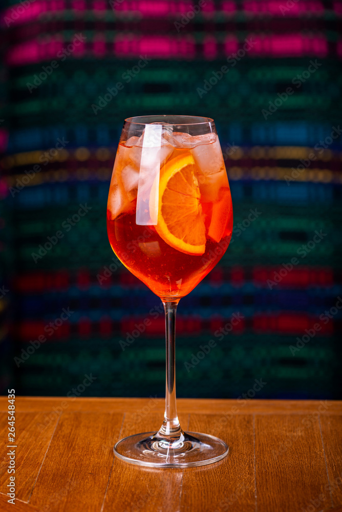 Aperol spritz cocktail in glass on wooden table in the interior of the restaurant.