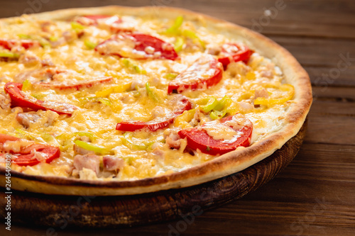 Appetizing pizza on a wooden background