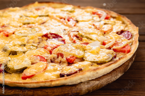 Appetizing pizza on a wooden background