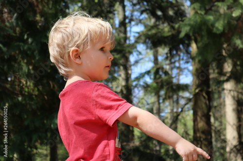 Child playing in forest
