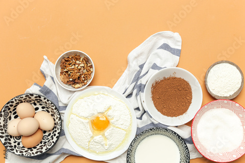 Creating a recipe, Top view of the basic baking ingredients on the orange table, cooking concept. 