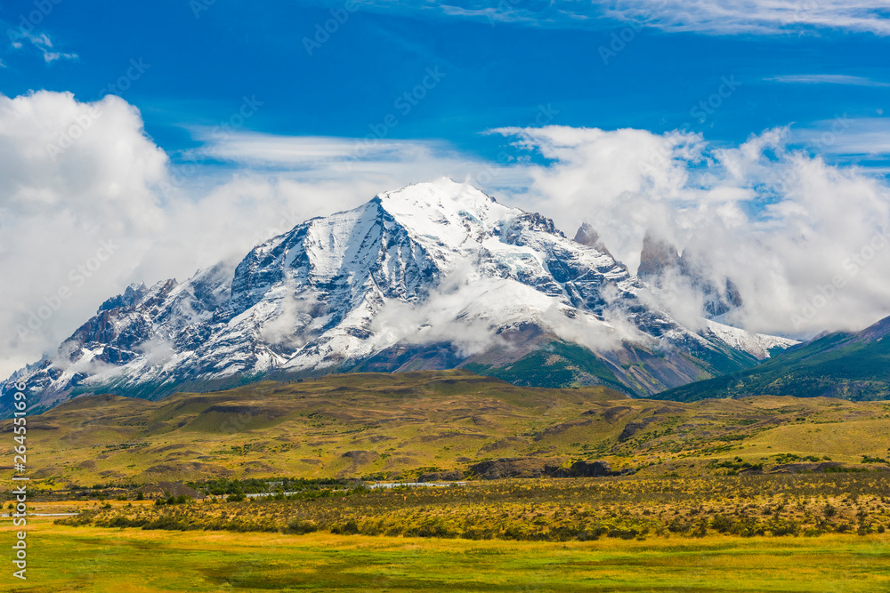 Fototapeta premium Torres del Paine peaks coming from clouds