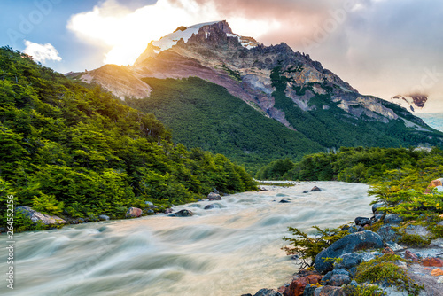 Sun is setting over the mountains and Fitz Roy river at Los Glaciares National Park