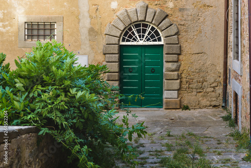 Very old door of the house in a Tuscan village.