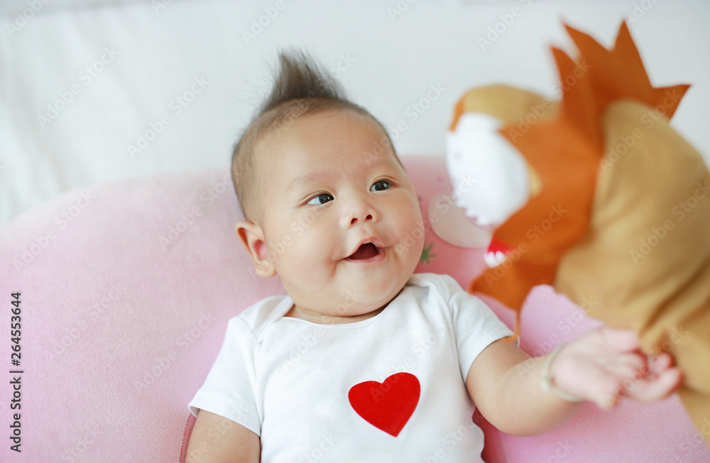 Mother playing animal puppet with her infant baby boy on the bed room at home. Mother playing animal puppet with her infant baby boy on the bed room at home.
