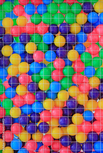 Colorful plastic balls in cage on children s playground.