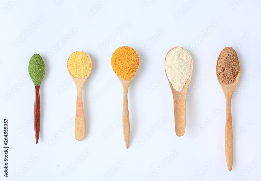 Various colorful powder in different wooden spoons isolated on white background. Various colorful powder in different wooden spoons isolated on white background.