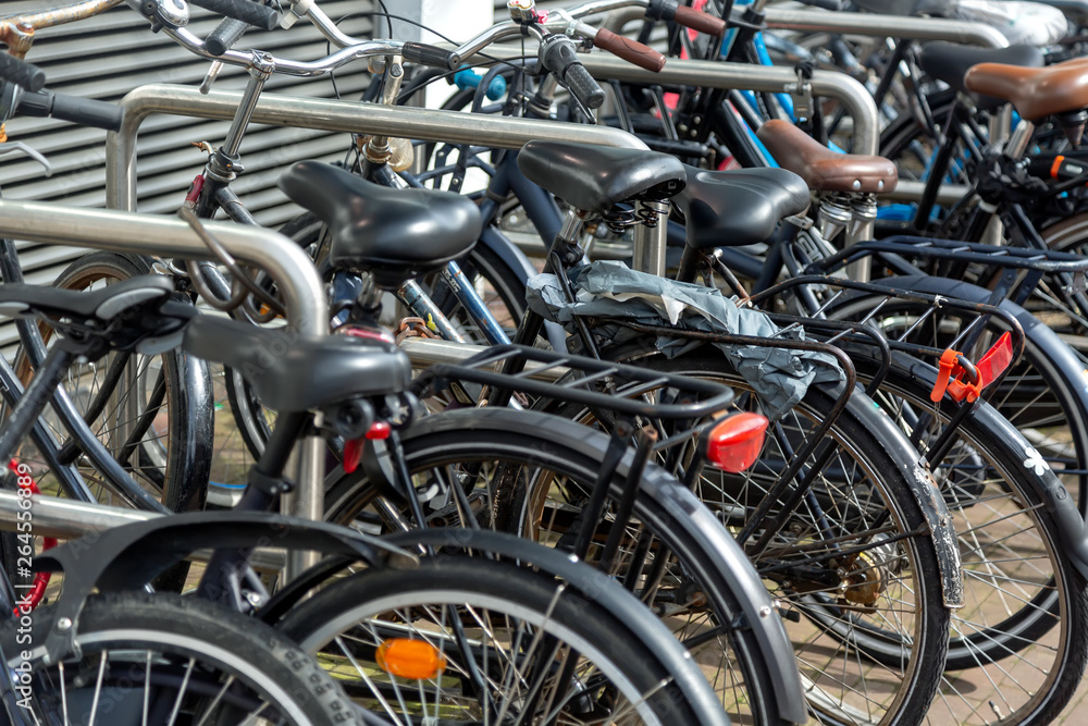 Bicycle parking lot in the city street of Amsterdam, Netherlands. Iconic transport in Amsterdam.