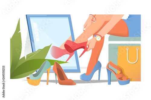 Beautiful young woman trying on high heel shoes while sitting on chair at the shoe store