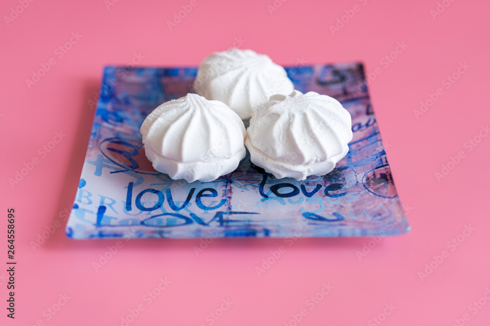 Pink and white marshmallows on a pink background Pink and white marshmallows on a pink background
