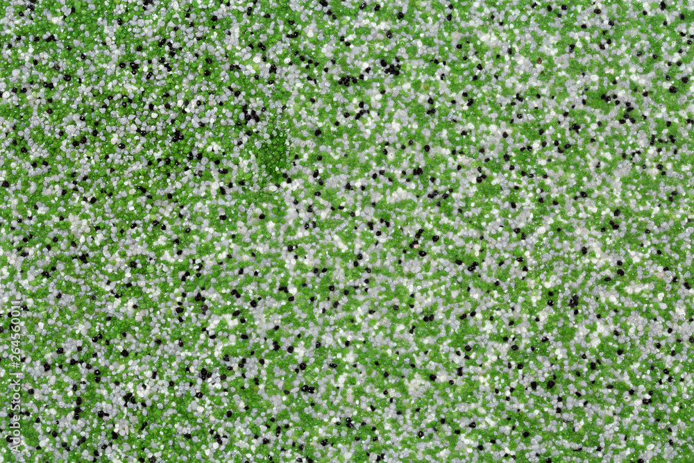 Extreme close up of decorative quartz sand epoxy floor or wall coating with green, grey, white and black coloured particles Extreme close up of decorative quartz sand epoxy floor or wall coating with green, grey, white and black coloured particles