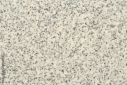 Extreme close up of decorative quartz sand epoxy floor or wall coating with different shades of grey, white and black coloured particles