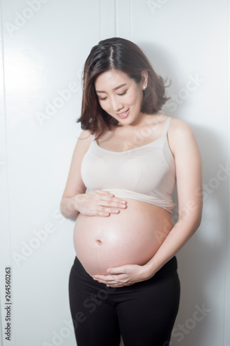 Beautiful asian pregnant woman expecting baby and touching her belly Free Download Beautiful asian pregnant woman expecting baby and touching her belly - GFXLoad