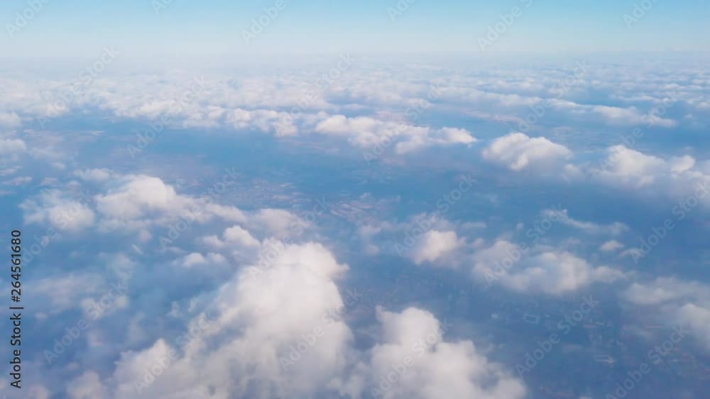 White fluffy clouds in blue sky, top view. View from air plane window. Flying over soft cloud White fluffy clouds in blue sky, top view. View from air plane window. Flying over soft cloud