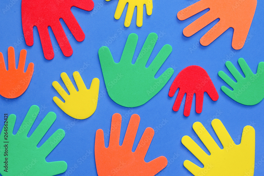 Fototapeta premium Abstract background of funky foam hands cutouts of different sizes in red, orange, yellow, green and blue