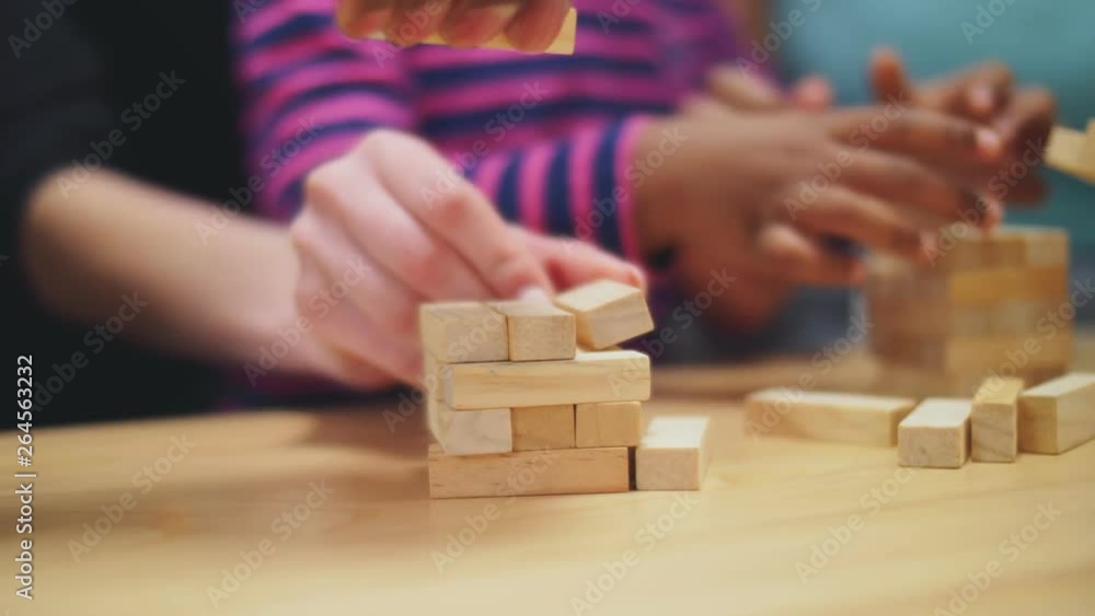 Close up of hands building jenga tower Close up of hands building jenga tower