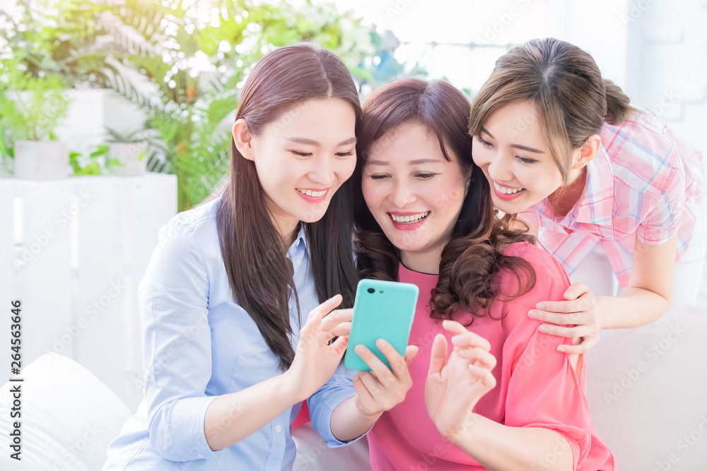 Daughters and mother use smartphone Daughters and mother use smartphone