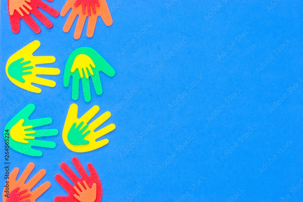Abstract background of funky foam hands cutouts of different sizes in red, orange, yellow, green and blue