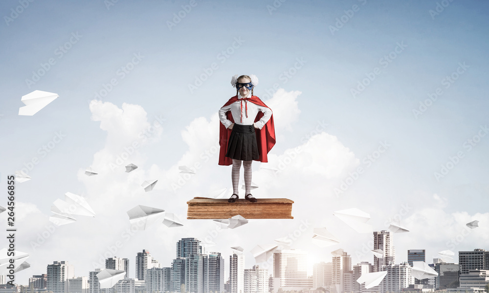 Girl power concept with kid wearing cape and mask and playing guardian. Mixed media Girl power concept with kid wearing cape and mask and playing guardian. Mixed media