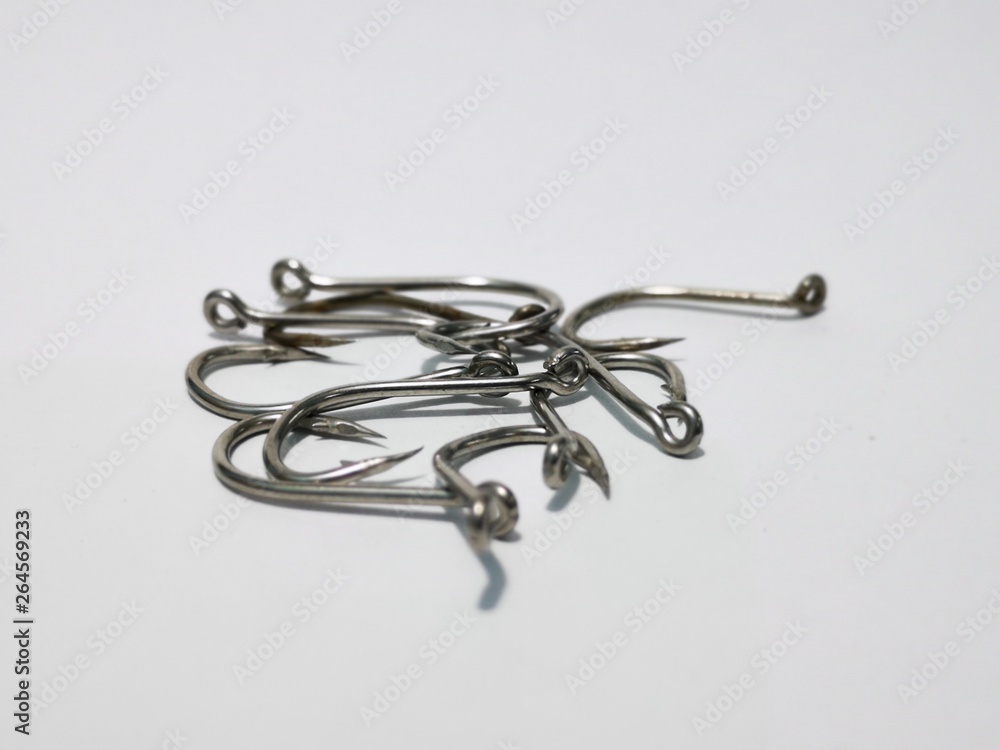 Closeup and macro shot of fishing accessories, fishing hock and fishing swivel with white background. Closeup and macro shot of fishing accessories, fishing hock and fishing swivel with white background.