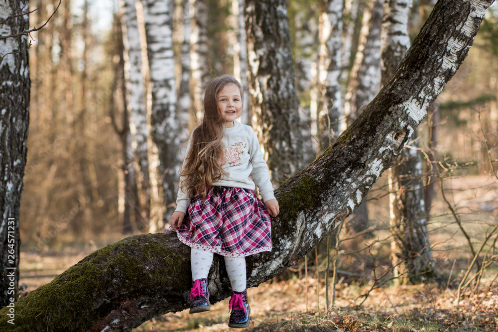 little girl with long hair sitting in the forest little girl with long hair sitting in the forest