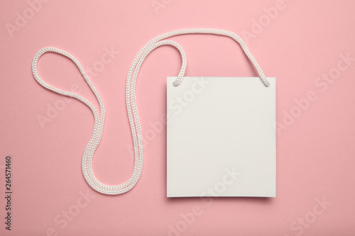 Isolated convention name badge, plastic tag id card mockup on pink background.