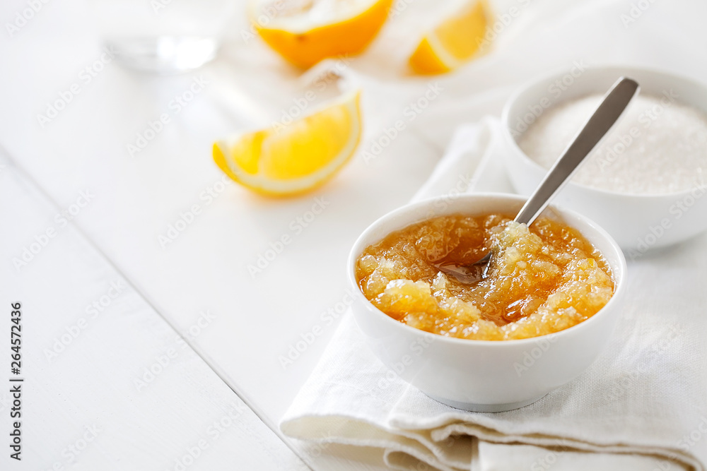 Trendy healthy homemade citrus lemon jam or confiture in a bowl on a white wooden background with copy space for text.Delicious dessert for Breakfast. Fruit preservation.Horizontal orientation Trendy healthy homemade citrus lemon jam or confiture in a bowl on a white wooden background with copy space for text.Delicious dessert for Breakfast. Fruit preservation.Horizontal orientation