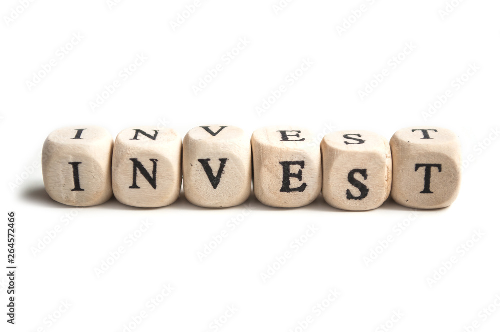 concept word on wooden cube on white background - Invest concept word on wooden cube on white background - Invest