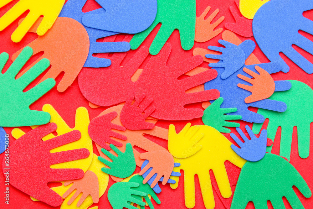 Abstract background of funky foam hands cutouts of different sizes in red, orange, yellow, green and blue