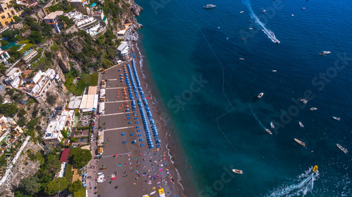 ship departs from the pier full tourist. Tourist Yacht Tour, water transport, traffic, license. rent vacation on the ship, boat. bay, beautiful sunny weather, vacation. aerial view Positano, Italy