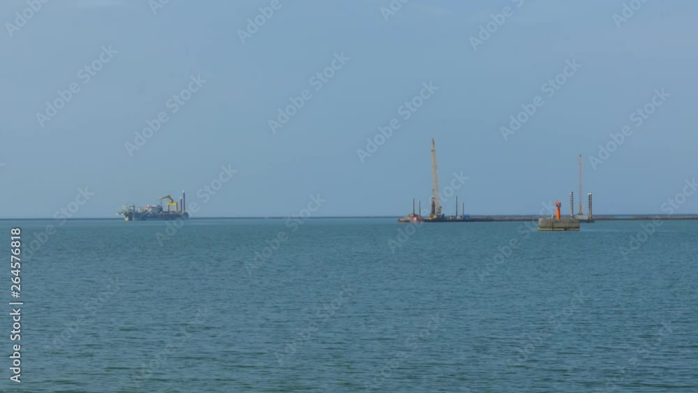 Pier dradger anchored at Port of Liepaja, wide shot Pier dradger anchored at Port of Liepaja, wide shot