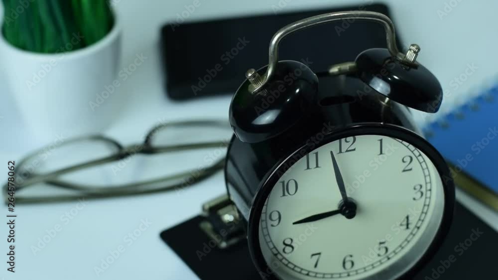 Clock ringing to 9 o'clock on Working Desk background Clock ringing to 9 o'clock on Working Desk background