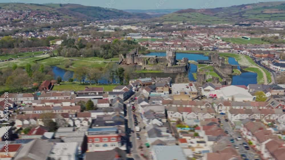 Long shot aerial orbit hyperlapse of Caerphilly Castle north of Cardiff, South Wales. Filmed on a Spring April morning with blue skies and bright sunshine on the DJI Mavic 2 Pro from DNG raw stills. Long shot aerial orbit hyperlapse of Caerphilly Castle north of Cardiff, South Wales. Filmed on a Spring April morning with blue skies and bright sunshine on the DJI Mavic 2 Pro from DNG raw stills.