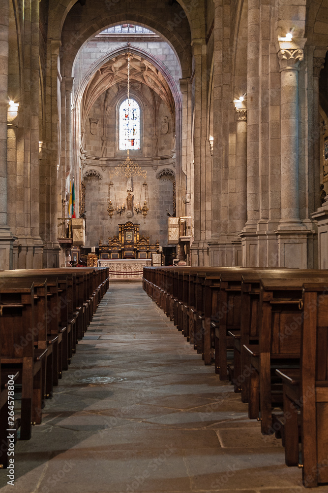 Braga, Portugal - December 28, 2017: Se de Braga Cathedral interior. Nave, main chapel and altar. Oldest Cathedral in Portugal. 11th century Romanesque with Gothic and Baroque adding
