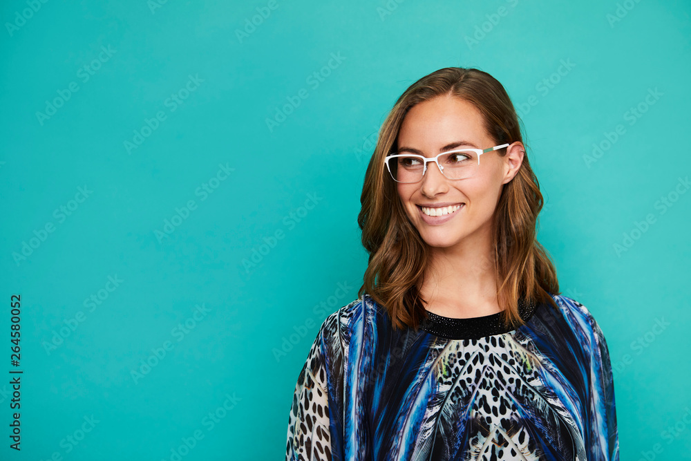 Smiling woman in blue top with glasses Smiling woman in blue top with glasses
